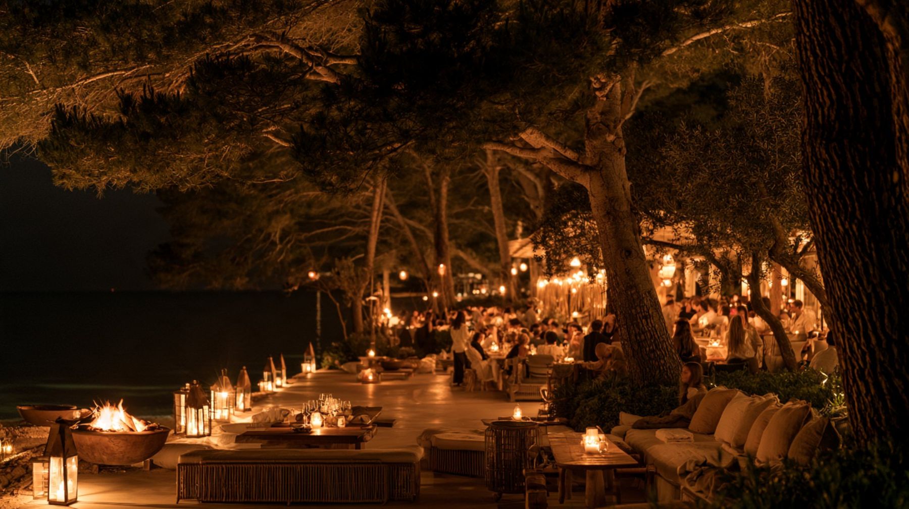 Night under the pines by the sea, lanterns and fire bowls